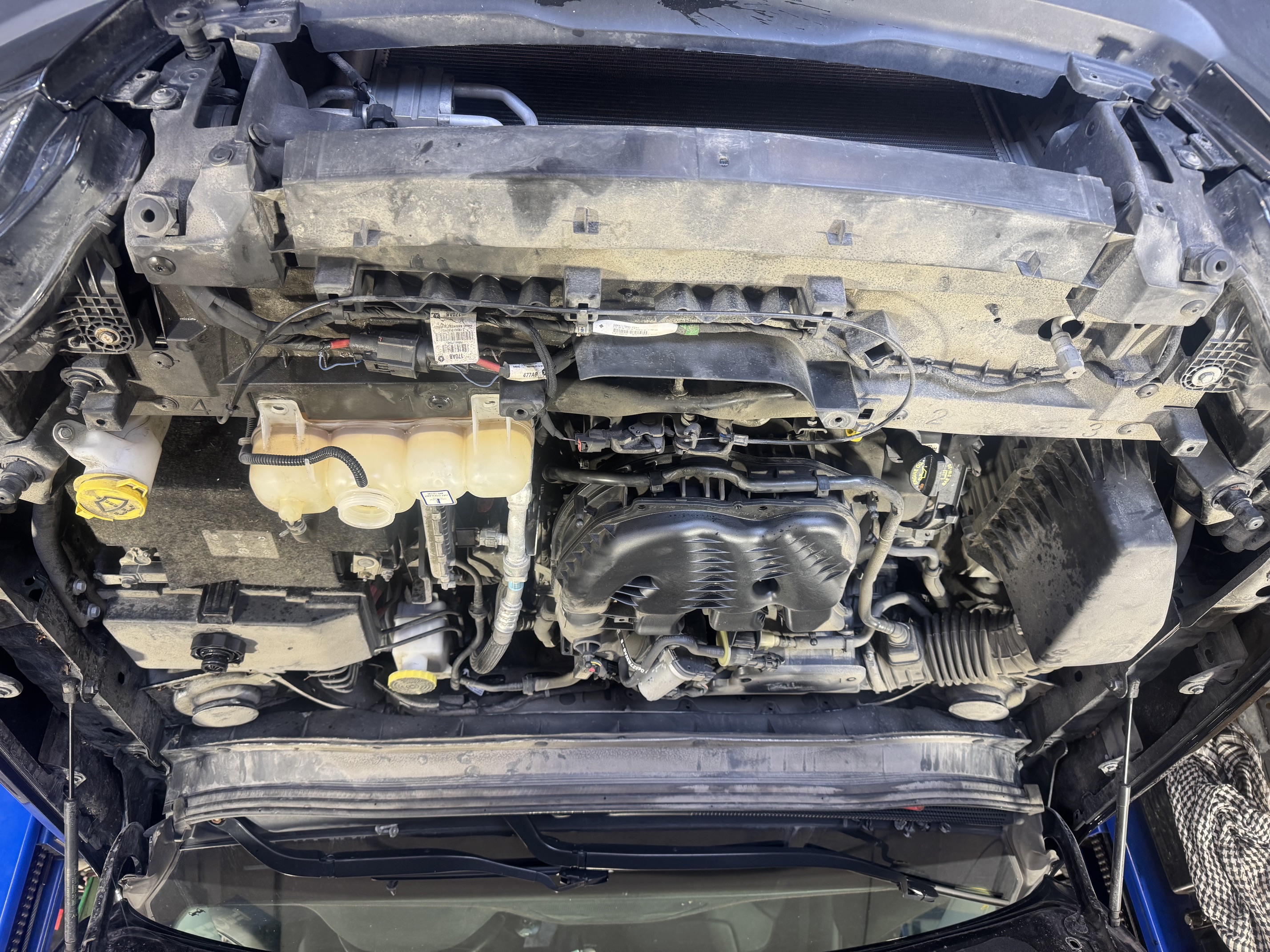 Close-up of a vehicle engine bay at the shop